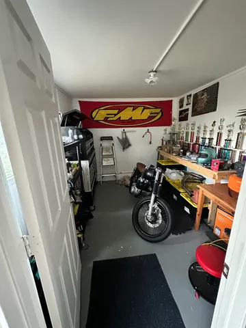 a living room with lots of furniture and a large window