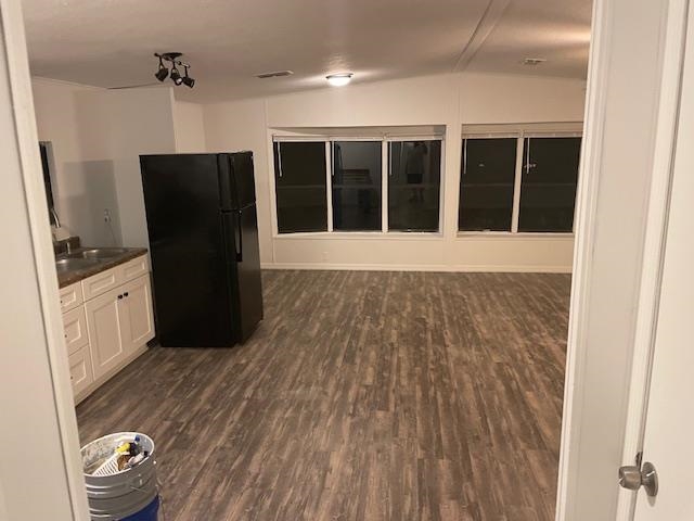 272 Pizarro Road St. Augustine, FL 32080 - Photo 2 of 23 an empty room with wooden floor and cabinet