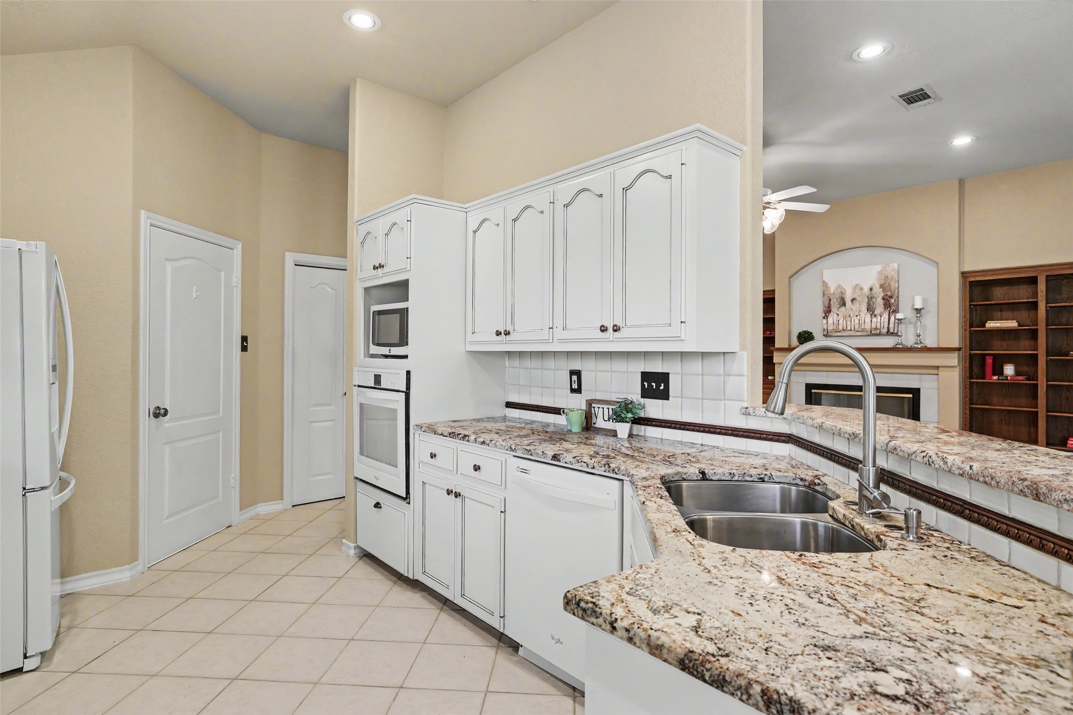 30107 Hamlet Circle Georgetown, TX 78628 - Photo 10 of 40 Granite counters and stainless steel appliances complete this bright kitchen.