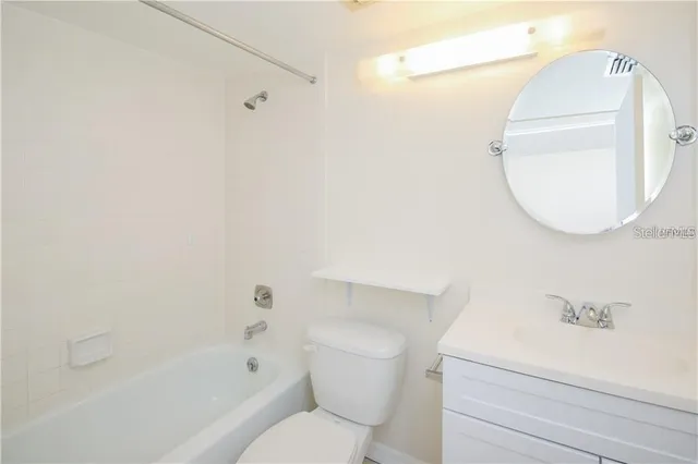 a room with lot of large windows and furniture