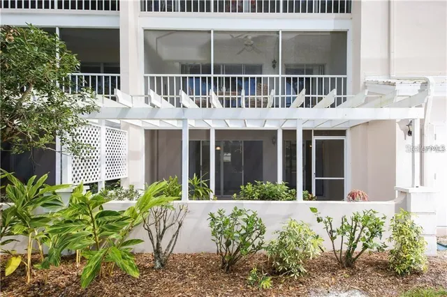 a front view of a building with a garden