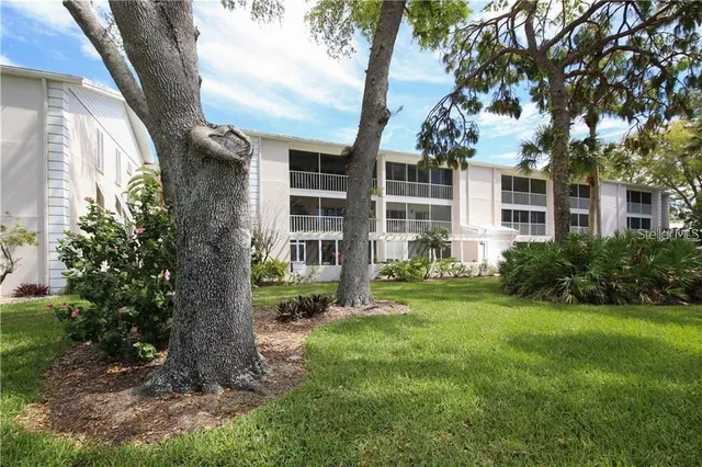 a backyard of a house with lots of green space and fountain