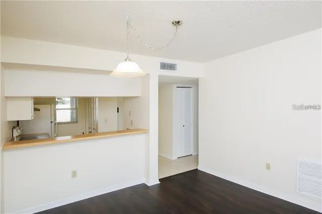 a view of a kitchen cabinets and wooden floor