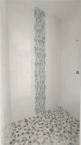 a bathroom with a glass shower door