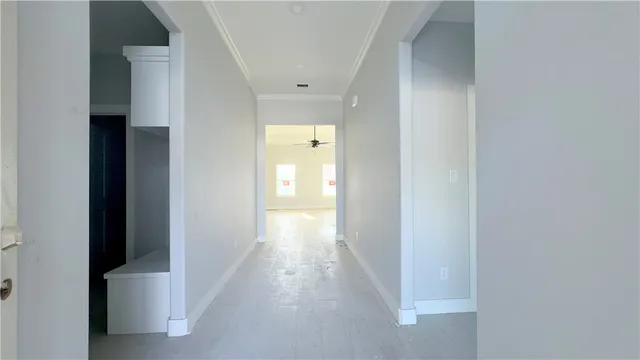 a view of a hallway with wooden floor