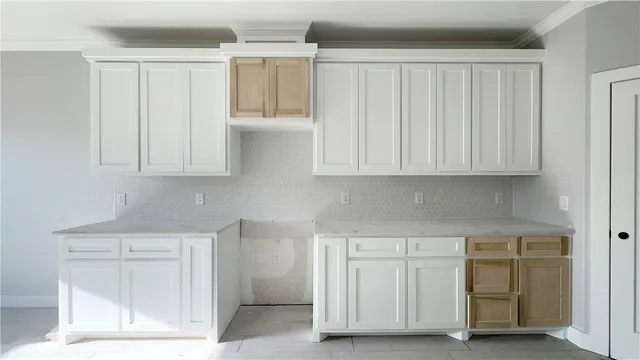 a kitchen with white cabinets