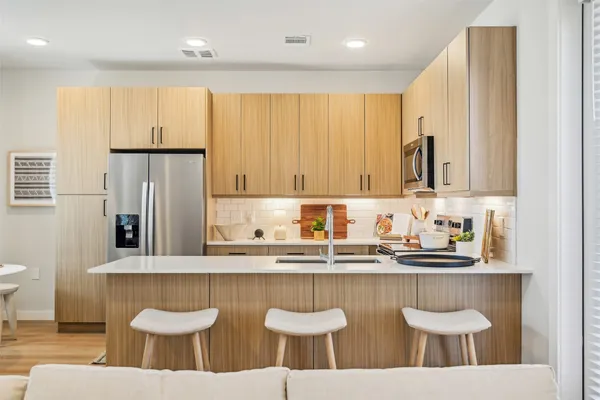 a kitchen with stainless steel appliances granite countertop a sink and a white cabinets