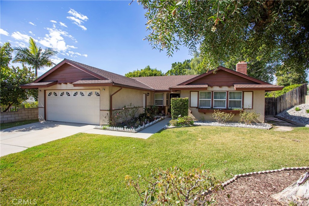 1085 Tamarack Avenue Brea, CA 92821 - Photo 1 of 28 a front view of a house with a garden and porch