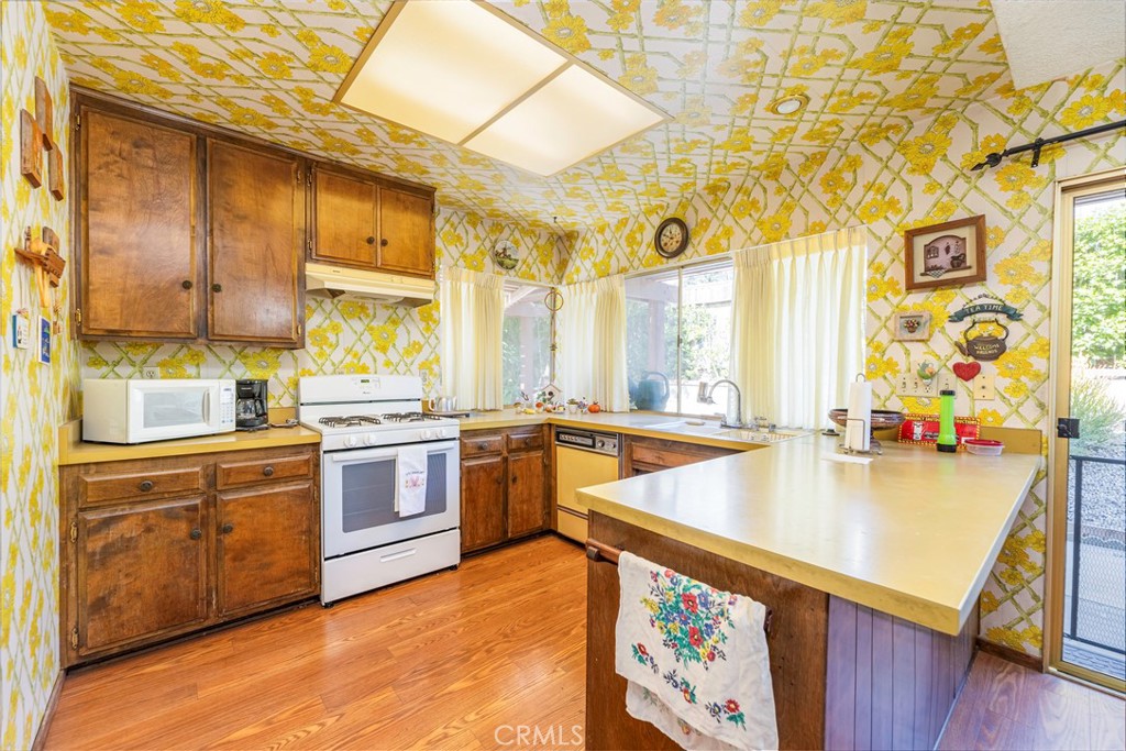 1085 Tamarack Avenue Brea, CA 92821 - Photo 11 of 28 a large kitchen with stainless steel appliances granite countertop a sink and cabinets
