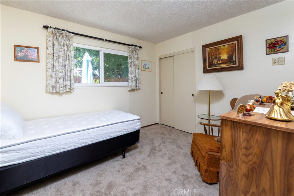 1085 Tamarack Avenue Brea, CA 92821 - Photo 19 of 28 a bedroom with furniture and a window