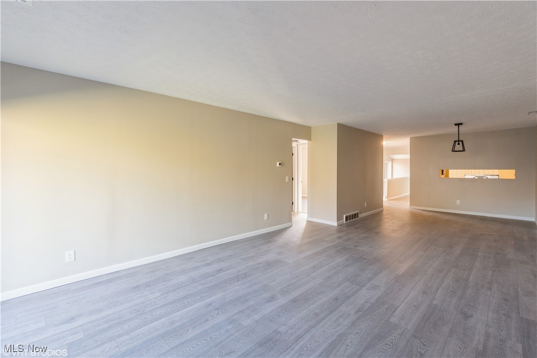 3725 Mayfield Road Cleveland Heights, OH 44121 - Photo 5 of 16 Unfurnished room with wood-type flooring and a textured ceiling