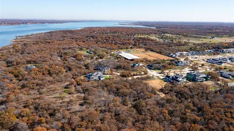 an aerial view of residential house with parking and yard
