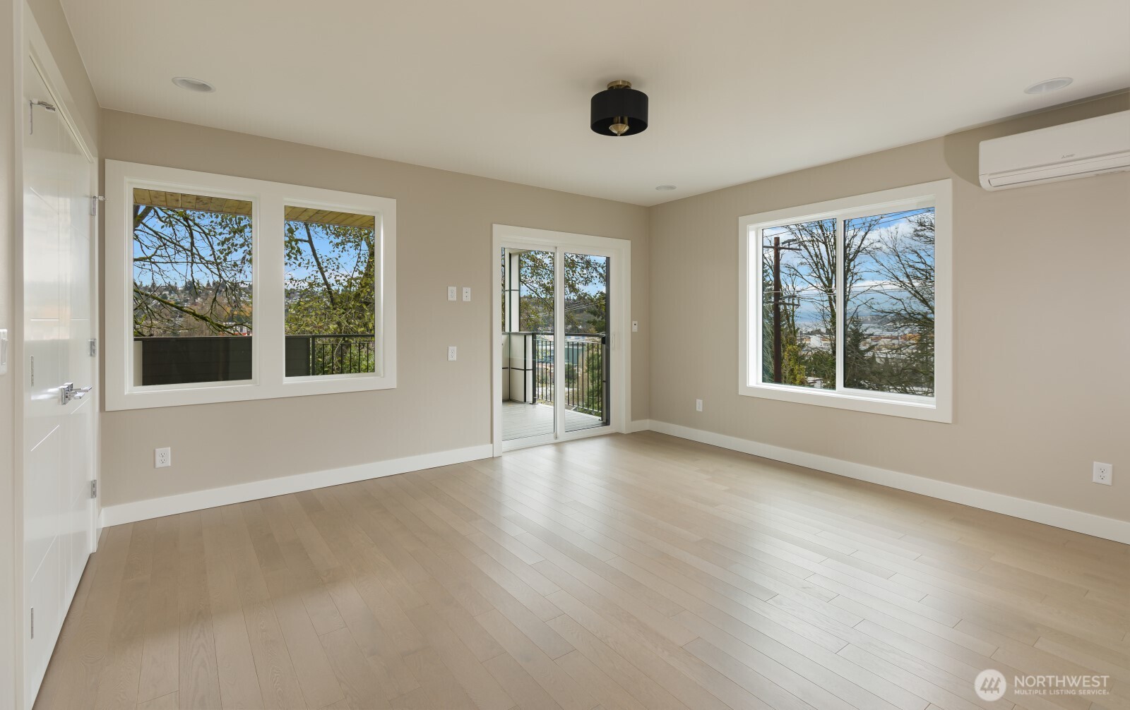 4009 21st Avenue Southwest Seattle, WA 98106 - Photo 18 of 36 a view of an empty room with a window and wooden floor