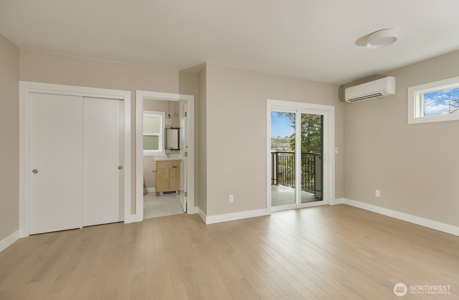 4009 21st Avenue Southwest Seattle, WA 98106 - Photo 23 of 36 a view of an empty room with wooden floor and a window