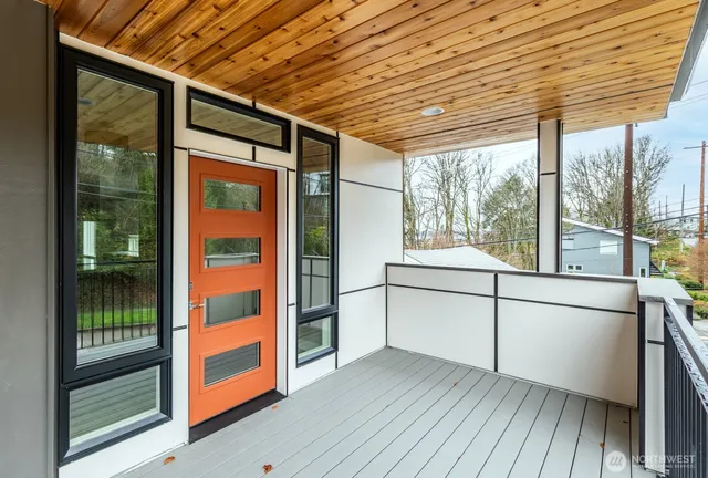 a view of a porch with wooden floor and iron stairs