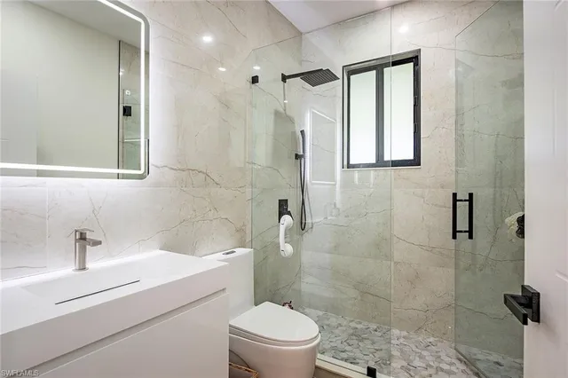 a bathroom with a sink toilet and shower