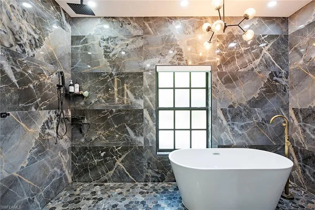 a bath tub sitting next to a white sink