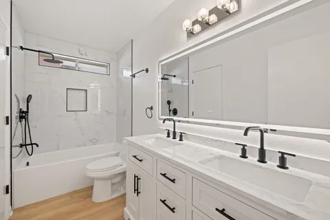 a bathroom with a sink a toilet and a tub