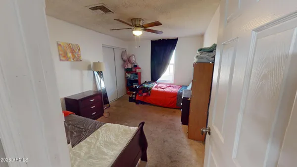 a living room with furniture rug and a ceiling fan