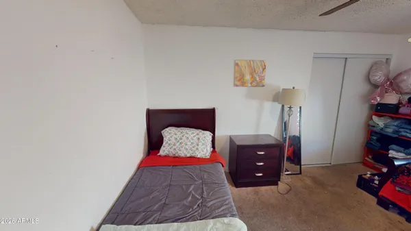 a bedroom with a bed and a dresser