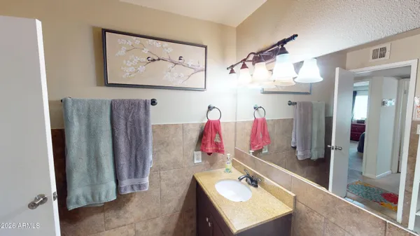 a bathroom with a sink vanity and a mirror