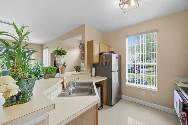 a living room with furniture a large window with potted plants
