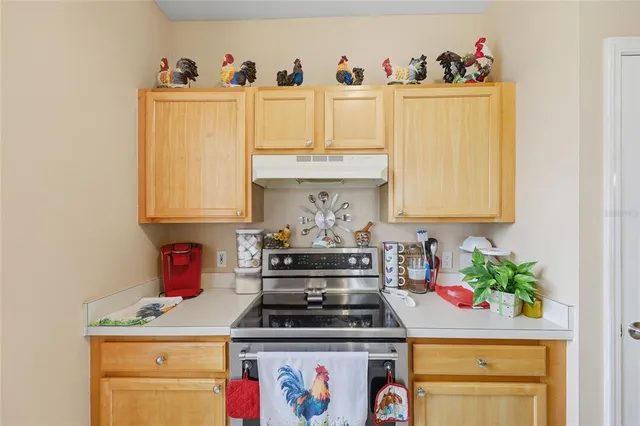 a kitchen with a stove and cabinets