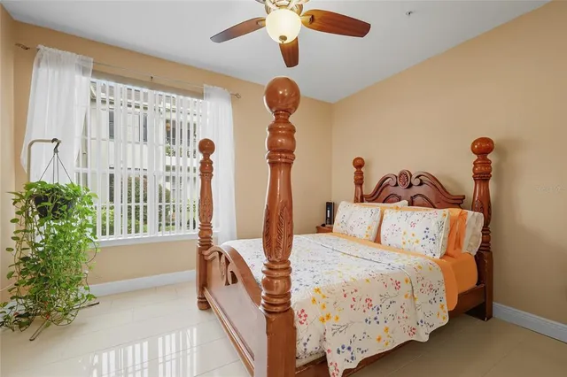 a bedroom with bed and a chandelier