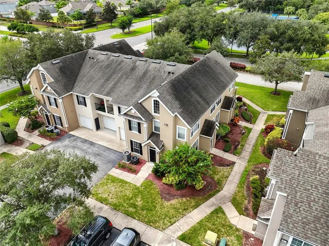an aerial view of a house with a yard basket ball court and outdoor seating
