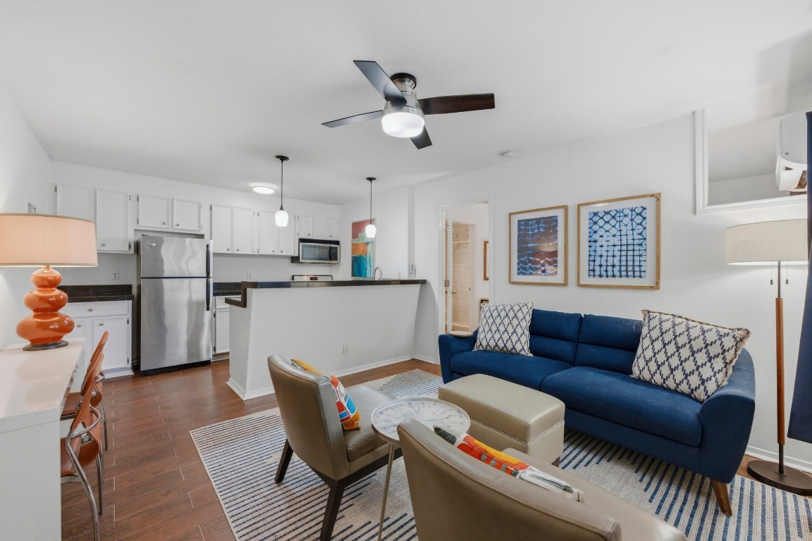 a living room with furniture and kitchen view