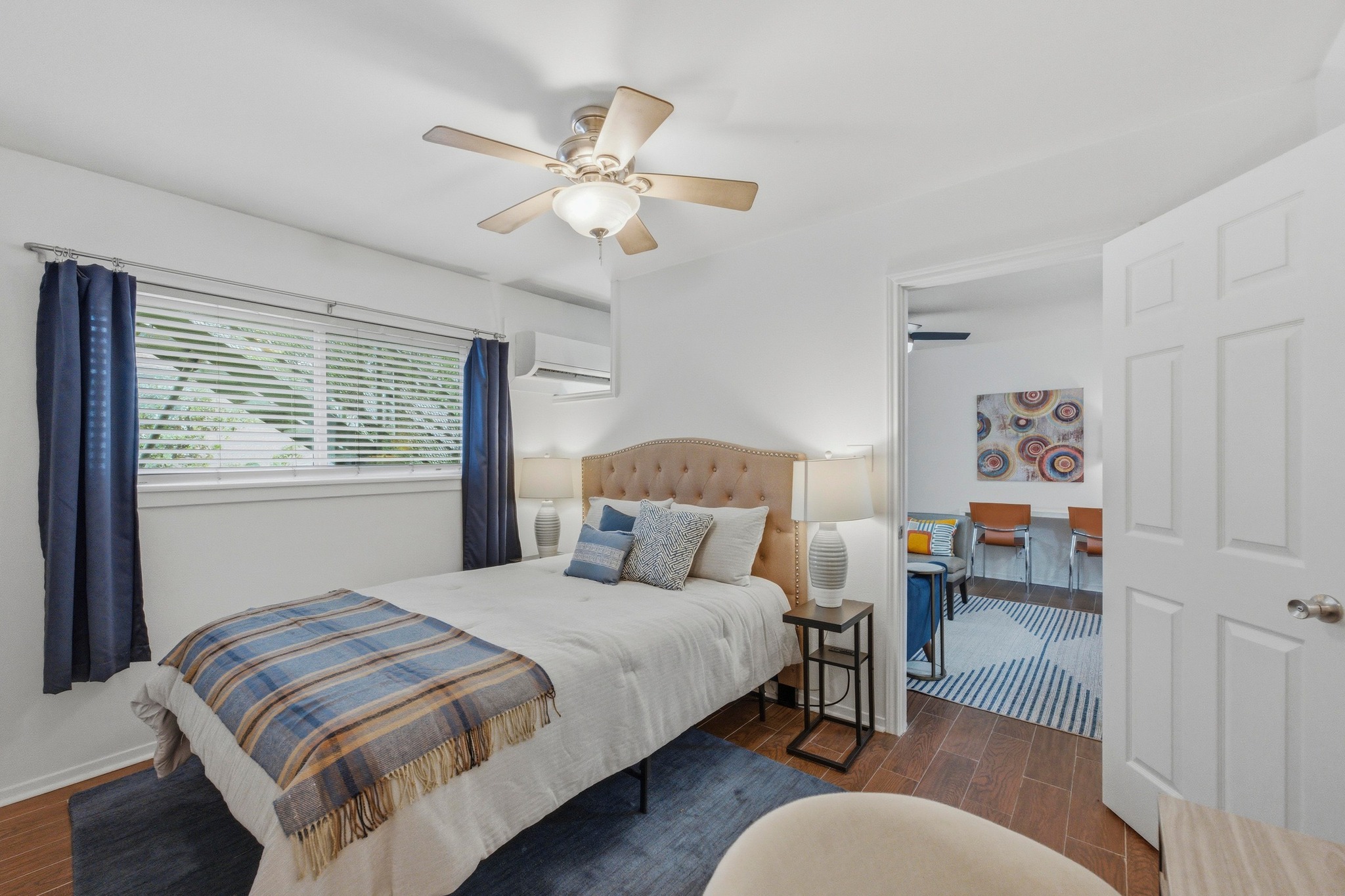 304 East 33rd Street, Unit 11 Austin, TX 78705 - Photo 11 of 27 a bedroom with a bed and a chandelier