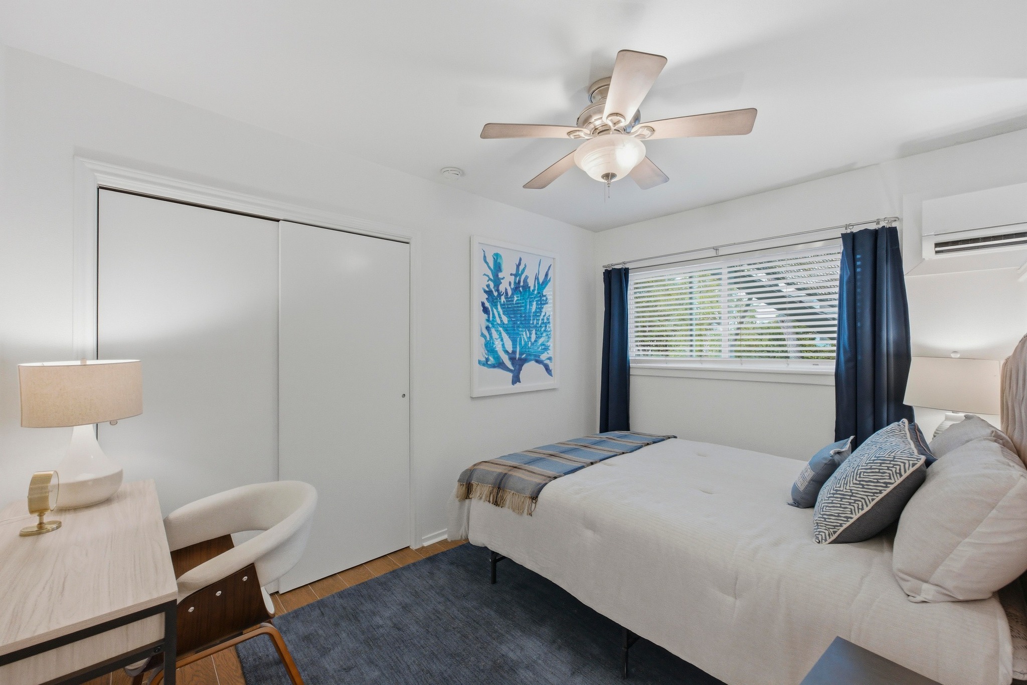 304 East 33rd Street, Unit 11 Austin, TX 78705 - Photo 13 of 27 a bedroom with a bed and a chandelier