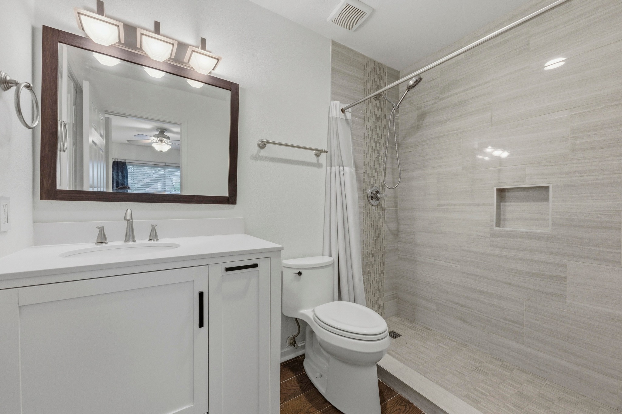 304 East 33rd Street, Unit 11 Austin, TX 78705 - Photo 15 of 27 a bathroom with a toilet a sink a vanity and mirror