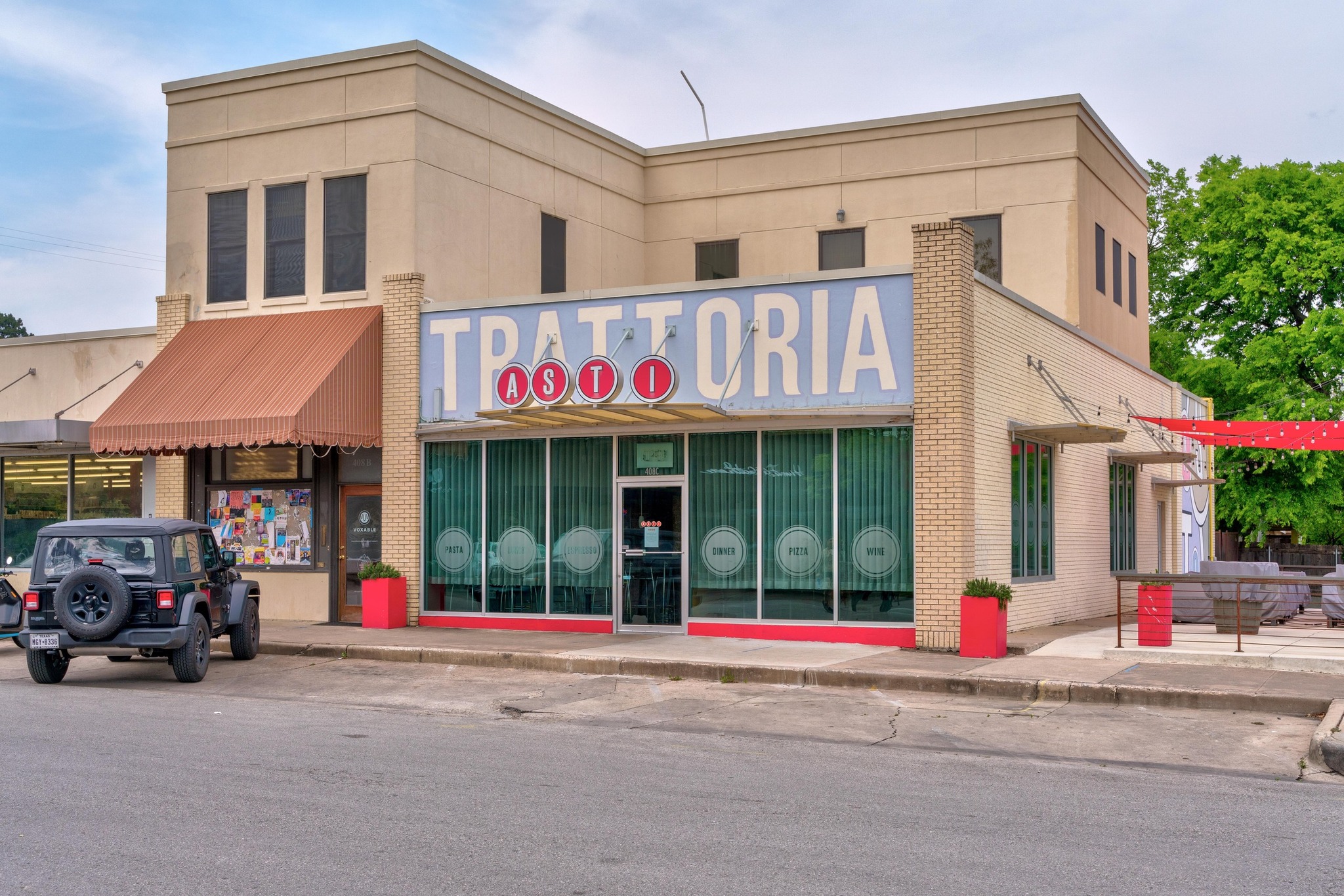 304 East 33rd Street, Unit 11 Austin, TX 78705 - Photo 23 of 27 a view of a brick building with a large window and a parked car