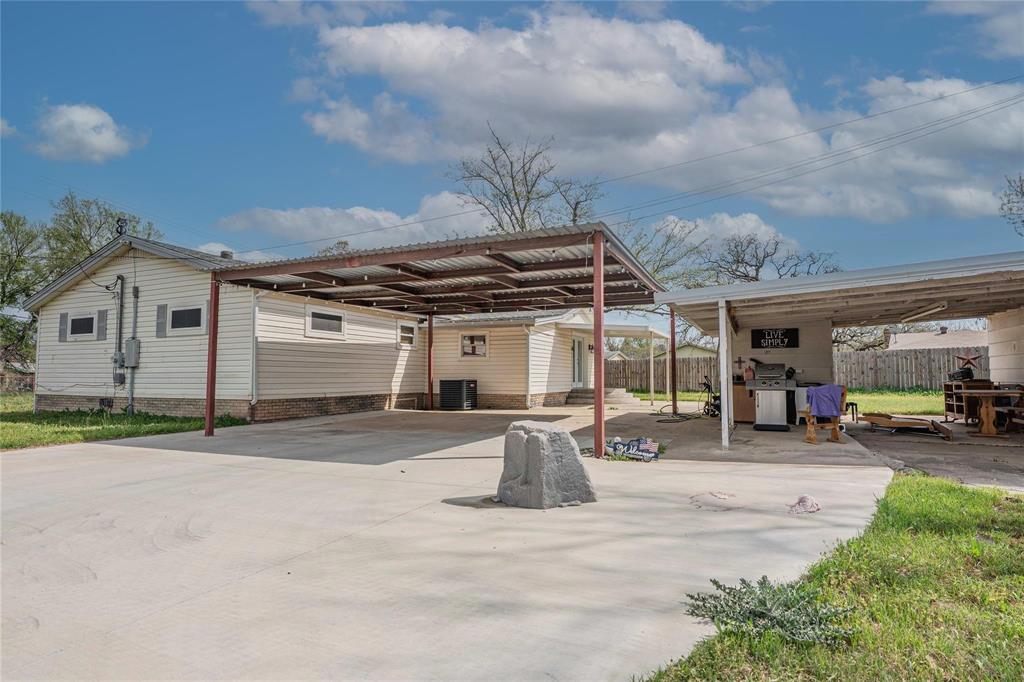 900 Silver Creek Azle Road Azle, TX 76020 - Photo 4 of 27 Concrete driveway with dual carports featuring metal roofing