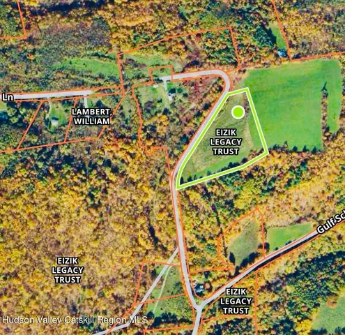 a sign that is sitting in front of a tree