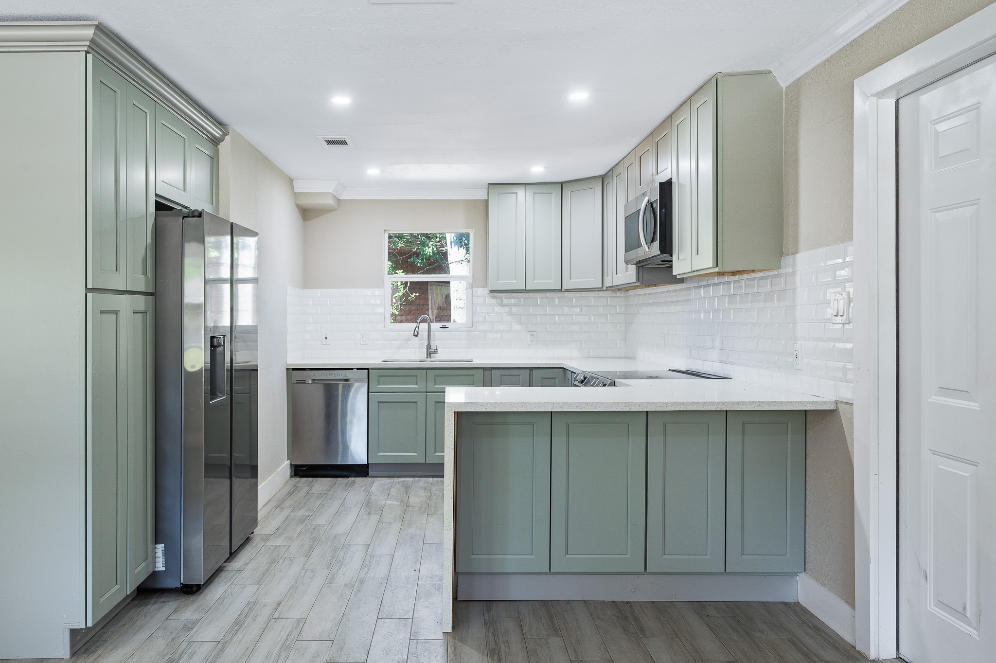 a kitchen with stainless steel appliances granite countertop a sink stove and refrigerator