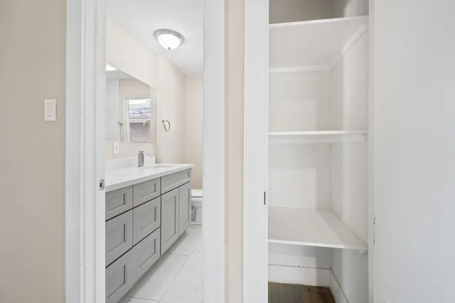 a bathroom with a shower sink and mirror