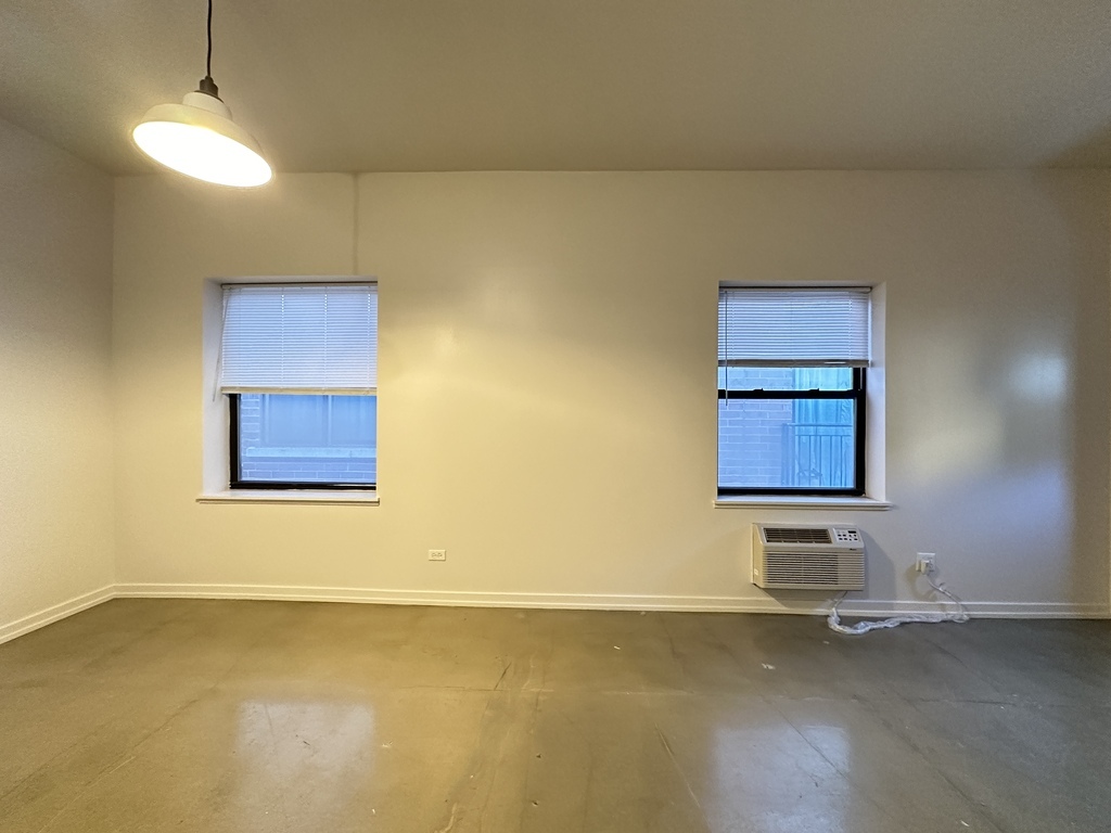1136 West Wilson Avenue, Unit 202 Chicago, IL 60640 - Photo 14 of 19 a view of an empty room and window