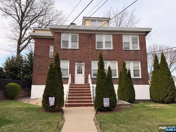 a view of a house with a yard and a floor to ceiling window
