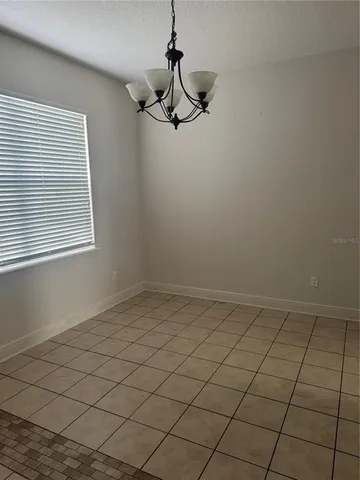 a view of a room with window and ceiling fan