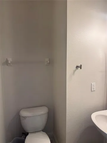 a white toilet sitting next to a bathroom sink