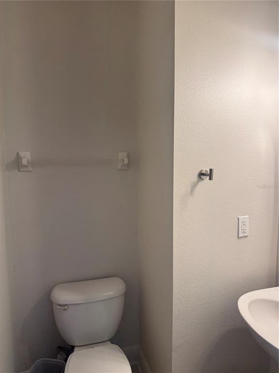 12976 Borland Street Windermere, FL 34786 - Photo 8 of 15 a white toilet sitting next to a bathroom sink