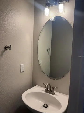 a bathroom with a sink and mirror