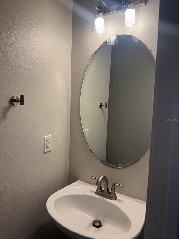 12976 Borland Street Windermere, FL 34786 - Photo 9 of 15 a bathroom with a sink and mirror