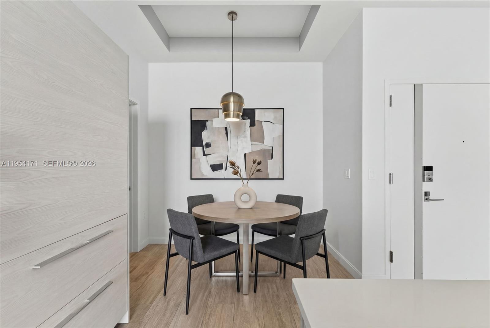 45 Southwest 9th Street, Unit LPH4609 Miami, FL 33130 - Photo 13 of 50 a view of a dining room with furniture and wooden floor