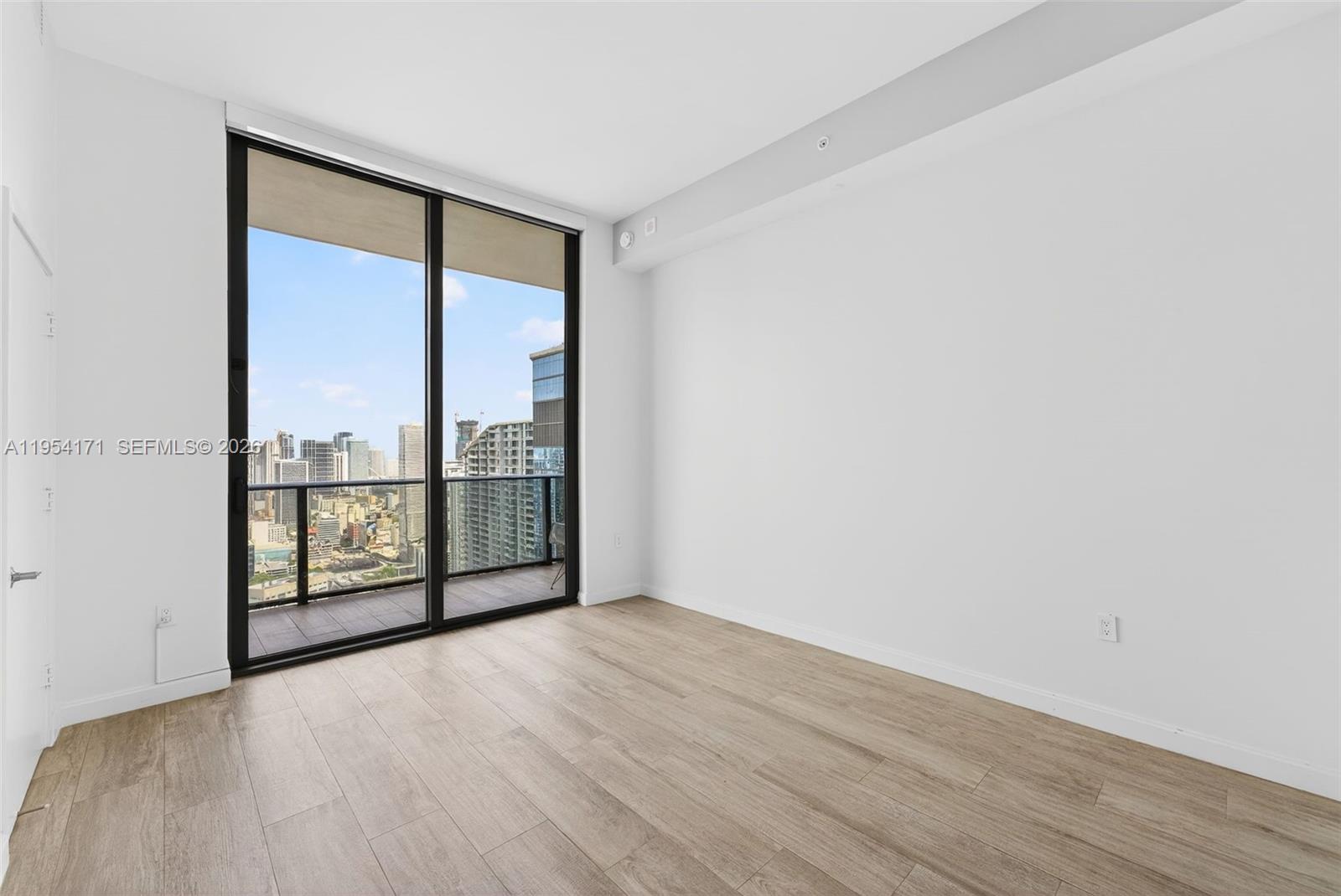 45 Southwest 9th Street, Unit LPH4609 Miami, FL 33130 - Photo 17 of 50 an empty room with wooden floor and windows