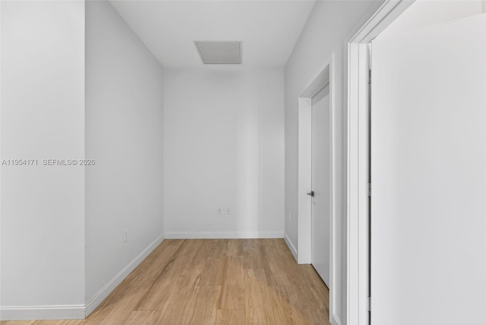 45 Southwest 9th Street, Unit LPH4609 Miami, FL 33130 - Photo 23 of 50 a view of a small space with wooden floor and a window