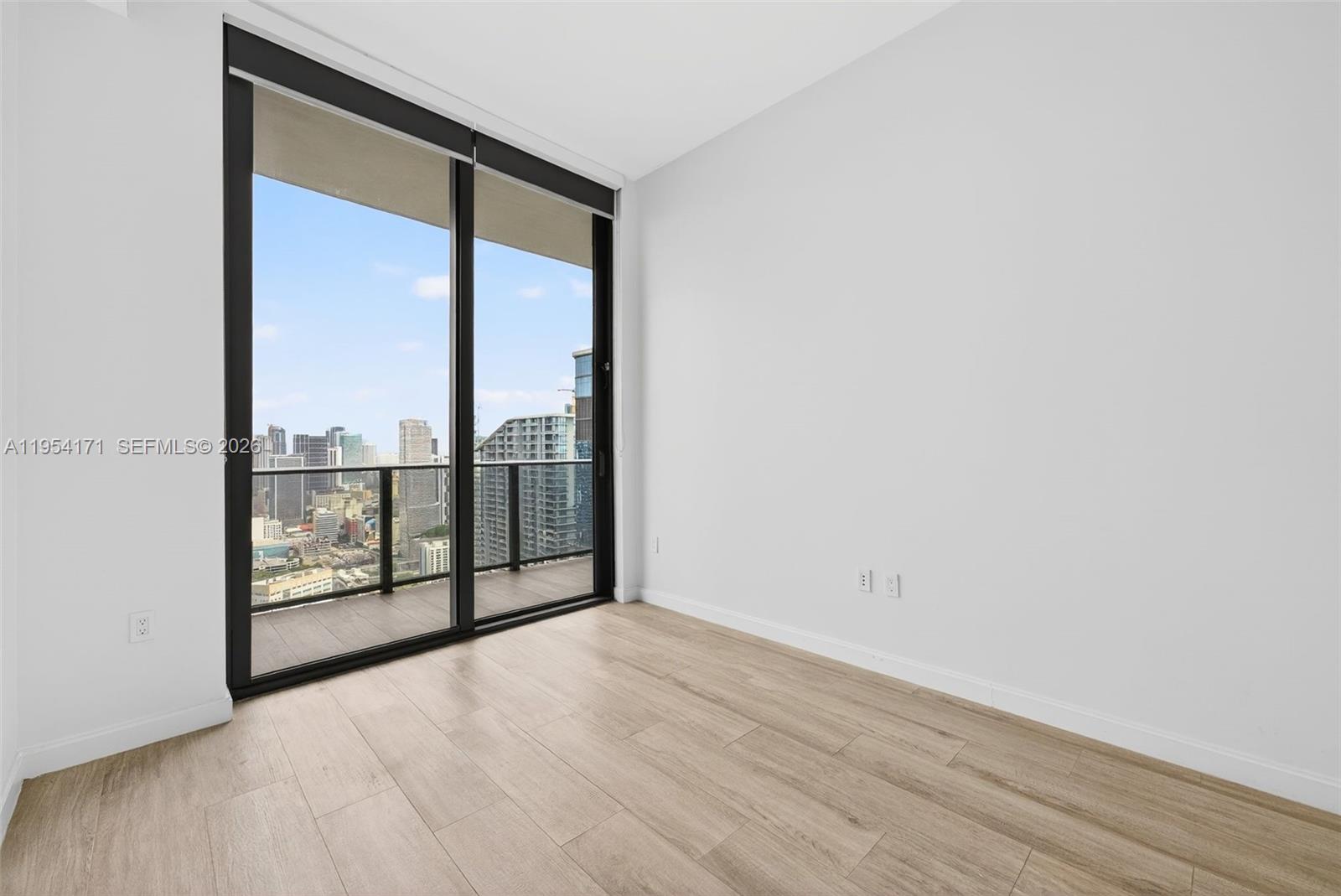 45 Southwest 9th Street, Unit LPH4609 Miami, FL 33130 - Photo 28 of 50 an empty room with sliding door and mountain view
