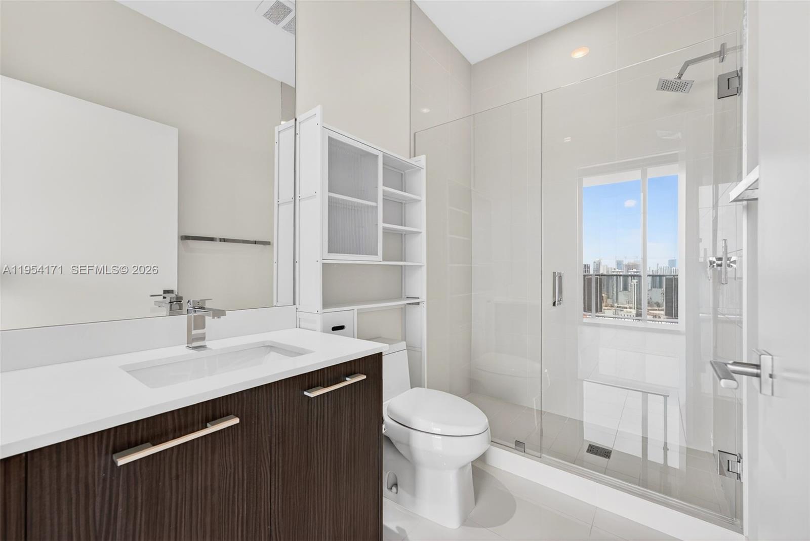 45 Southwest 9th Street, Unit LPH4609 Miami, FL 33130 - Photo 34 of 50 a bathroom with a sink a toilet and shower